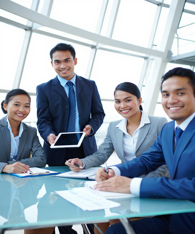 Professional Indonesian maritime recruitment team at PT Arta Bahari Indonesia discussing crew placement for cruise and merchant vessels